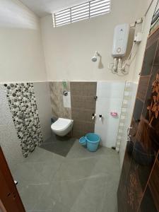 a bathroom with a toilet and a sink and a shower at NDM Homestay 2BHK in Sibsāgar