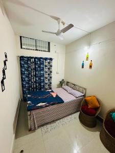 a bedroom with a bed and a ceiling fan at NDM Homestay 2BHK in Sibsāgar