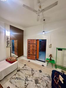 a living room with a couch and a table at NDM Homestay 2BHK in Sibsāgar +3 photos