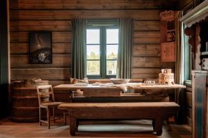 a room with wooden walls and a window and a table at Hylja Lodge in Vaga +16 photos