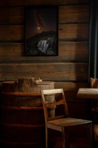a wooden wall with a chair and a picture at Hylja Lodge in Vaga