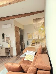 a living room with a couch and a bed at Studio cosy Le3bis proche Cap d'Agde in Bessan +5 photos
