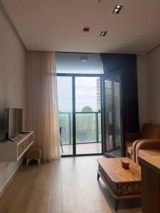 a living room with a large sliding glass door at Apartment in Gonio in Kvariati