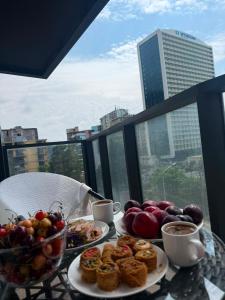 a table with plates of food and cups of coffee at Apartment in Gonio in Kvariati