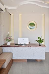 an office with a desk with a laptop on it at LUNA Hotel in Vĩnh Long