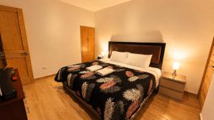 a bedroom with a large bed with two pillows at OXALAND HAUs in Oxapampa