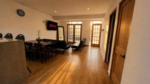 a living room with a dining room table and chairs at OXALAND HAUs in Oxapampa