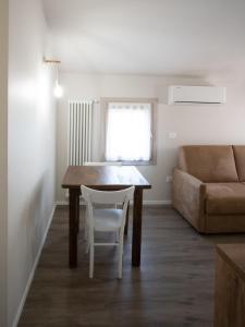 a living room with a table and a couch at Chioggia Apartment in Chioggia