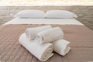 a bed with white towels on top of it at Chioggia Apartment in Chioggia