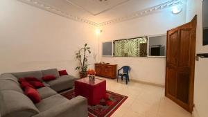a living room with a couch and a table at Adelhouse in Saint-Louis