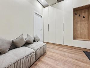 a living room with a couch and a closet at Rent&live beautiful apartment in Chişinău