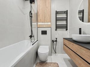 a white bathroom with a toilet and a sink at Rent&live beautiful apartment in Chişinău +22 photos