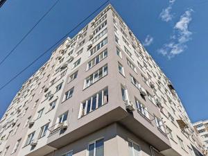 a tall building with windows on top of it at Rent&live beautiful apartment in Chişinău