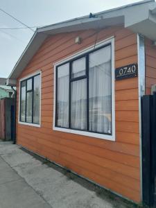 a orange building with windows on the side of it at Alojamiento Punta Arenas in Punta Arenas