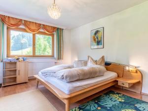 a bedroom with a large bed and a window at Hintermühltalhof in Itter