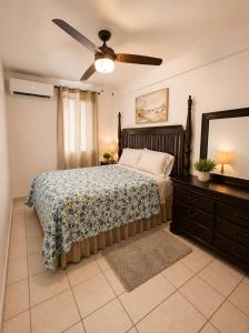 a bedroom with a bed and a ceiling fan at Natural Village ROOM #1,2,3 & 5 in San Juan