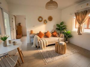 a living room with a couch and a table at Sunset Lover Beach Residence in Thong Sala
