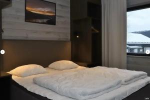 a large white bed with two pillows in a bedroom at Skistar Lodge Hemsedal in Hemsedal