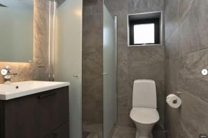 a bathroom with a toilet and a sink and a mirror at Skistar Lodge Hemsedal in Hemsedal