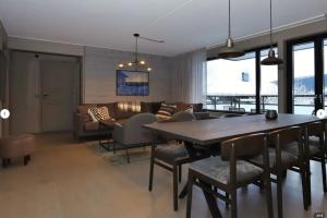 a dining room and living room with a table and chairs at Skistar Lodge Hemsedal in Hemsedal