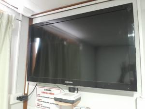 a flat screen tv hanging on a wall at Alojamiento Punta Arenas in Punta Arenas +5 photos