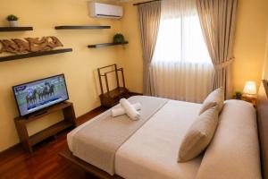 a bedroom with a bed and a television in it at Magnifica Planet Costa Dorada in Cambrils