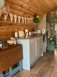 a kitchen with wooden ceilings and a counter top at Knockmany View Glamping in Augher