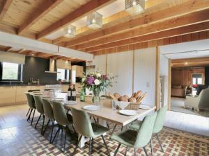 a dining room with a large wooden table and chairs at Relais de Zoé in Gesves
