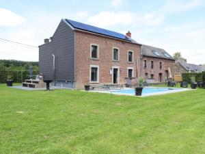 a house with a swimming pool in front of it at Relais de Zoé in Gesves