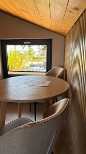 a table and chairs in a room with a window at Monic Apart Zefir in Mechelinki +10 photos