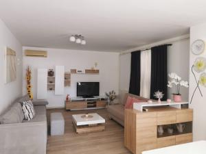 a living room with a couch and a tv at Family-friendly apartments with swimming pool Cepic, Central Istria - Sredisnja Istra - 11636 in Zatka Čepić