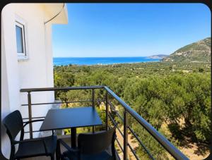 a balcony with chairs and a table and the ocean at Villa Dedi ,Borsh in Vane