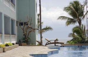 a view of the beach from the pool at the resort at Bamburi Beach Studio Apartment B41 in Bamburi