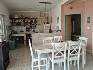 a kitchen with a white table and white chairs at Seaside secluded apartments Cove Skozanje, Hvar - 14899 in Gdinj +19 photos