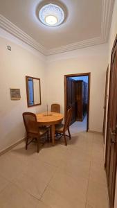 a dining room with a wooden table and chairs at Adelhouse in Saint-Louis