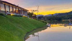 a building on a hill next to a body of water at Denbi Eco Lodge in Greater Aman