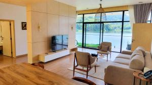 a living room with a couch and a television at Denbi Eco Lodge in Greater Aman +4 photos