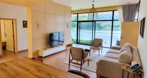 a living room with a couch and a television at Denbi Eco Lodge in Greater Aman