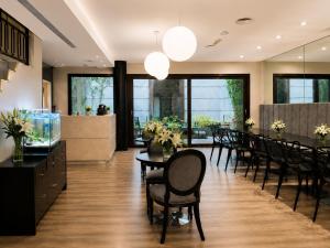 a dining room with tables and chairs and windows at Purobaires Hotel Boutique in Buenos Aires