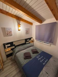 a bedroom with a bed with a large screen on the wall at La Era de Sandra in Sonseca +32 photos