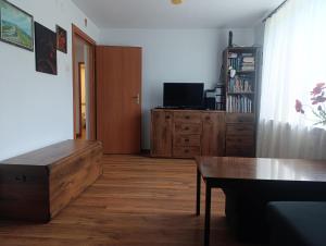 a living room with a table and a dresser at Apartament w Bieszczadach in Wołkowyja