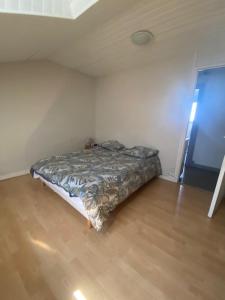 a bedroom with a bed in the corner of a room at T2 mansardé tout équipé in Limoges