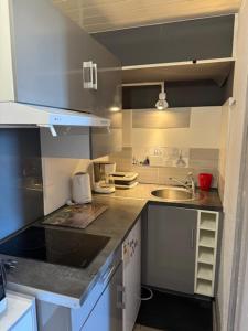 a small kitchen with a sink and a counter at T2 mansardé tout équipé in Limoges