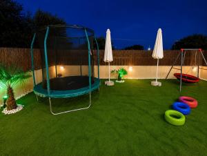 a playground with a trampoline and frisbees at JONNY'S Rooms in Paralia Katerinis