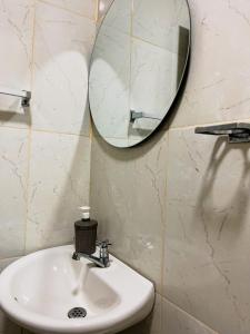 a bathroom with a sink and a mirror at Hostal La Bendición Buritaca in Santa Marta