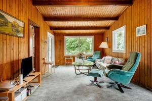 a living room with a couch and a table at 5020-Askeby-Faergensvaenge-18 in Askeby