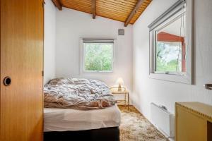 a bedroom with a bed and a window at 5020-Askeby-Faergensvaenge-18 in Askeby