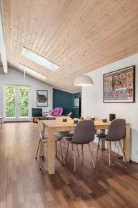 a dining room with a wooden table and chairs at fj1203-Jaegerspris-Birkagervej-14 in Jægerspris