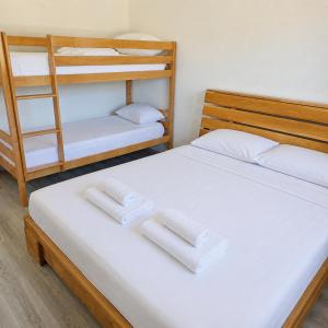 a bedroom with two bunk beds with white sheets at Villa ZANS in Gradačac +18 photos