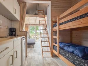 a small kitchen with a bunk bed in a house at Bumble bee in Ellemeet